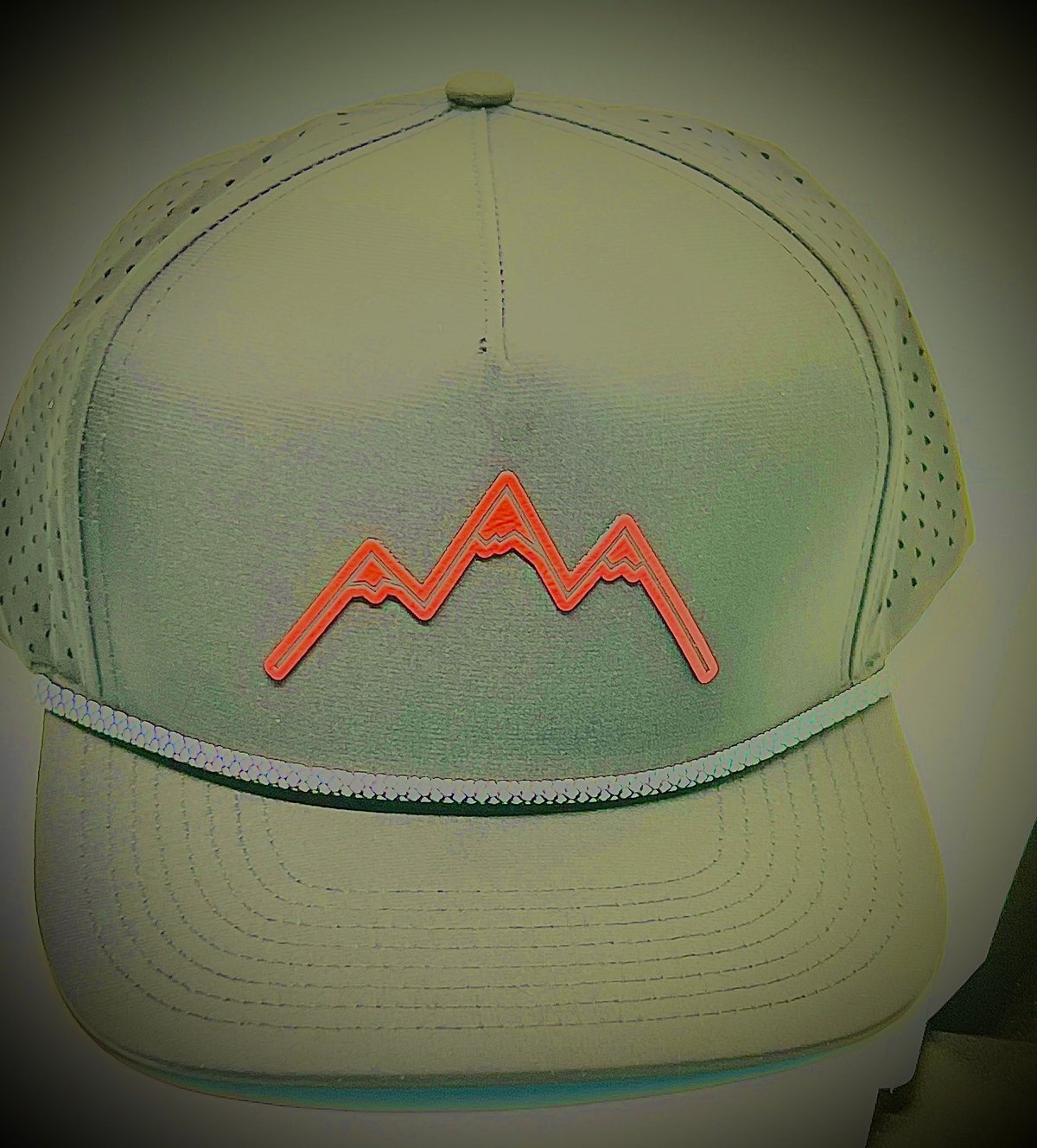 Mountain logo trucker cap with neon wavy mountain line design on front panel