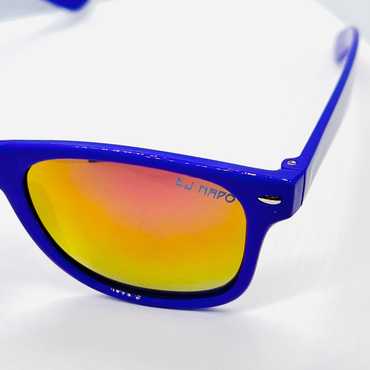 Pair of blue-framed sunglasses with gradient yellow-to-red mirrored lenses on white background