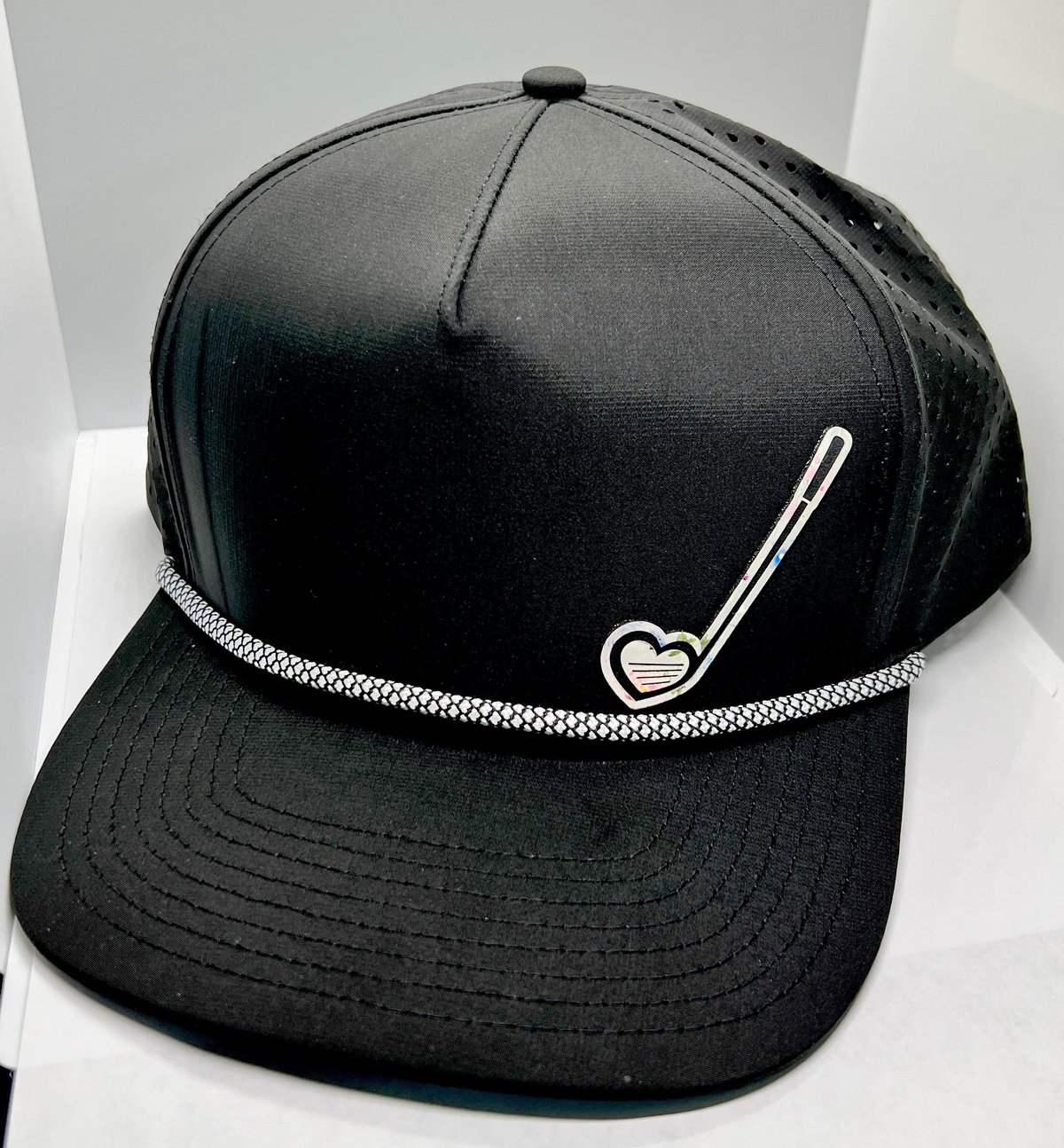 Black baseball cap with heart and golf club embroidery and decorative rope band detail