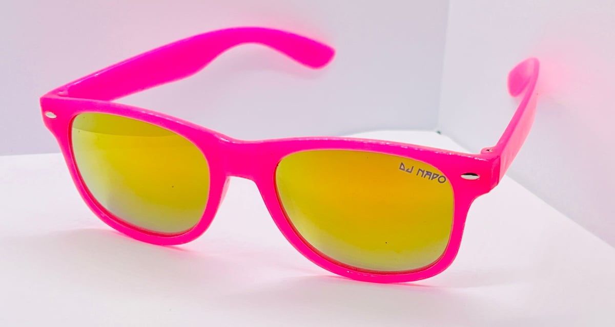 Bright neon pink wayfarer-style sunglasses with yellow mirrored lenses on a white surface