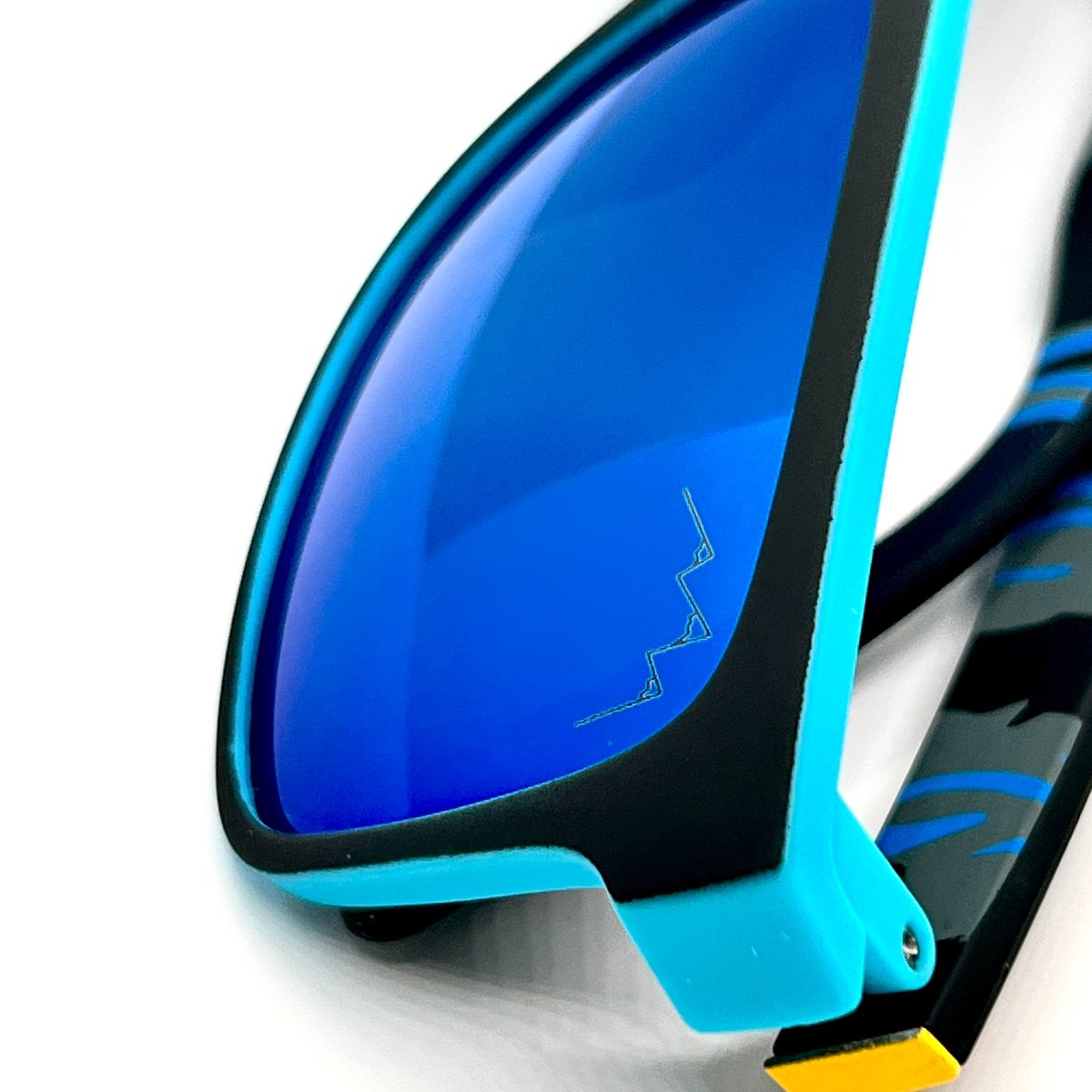 Bright blue sunglasses with Caribbean Blue mirrored lenses, the TLA mountain logo etched on the lens