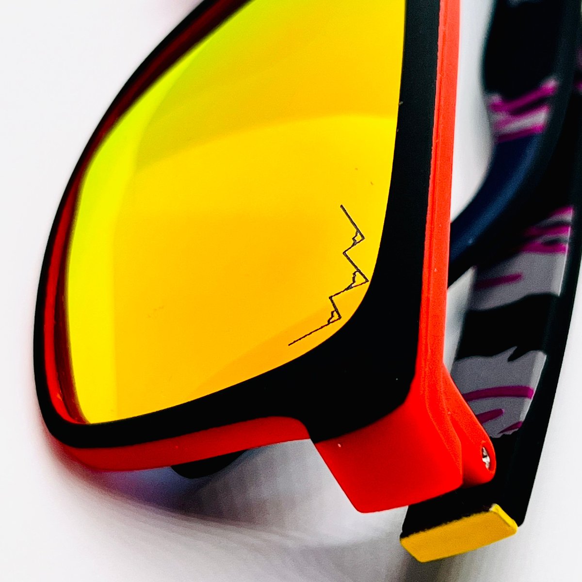 Red Niner frames from The OG Collection with bright yellow Prospector lenses and the TLA mountain logo etched on the lens